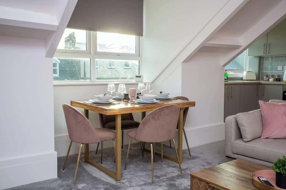 A sleek table for four awaits, surrounded by comfortable seating and bathed in natural light.