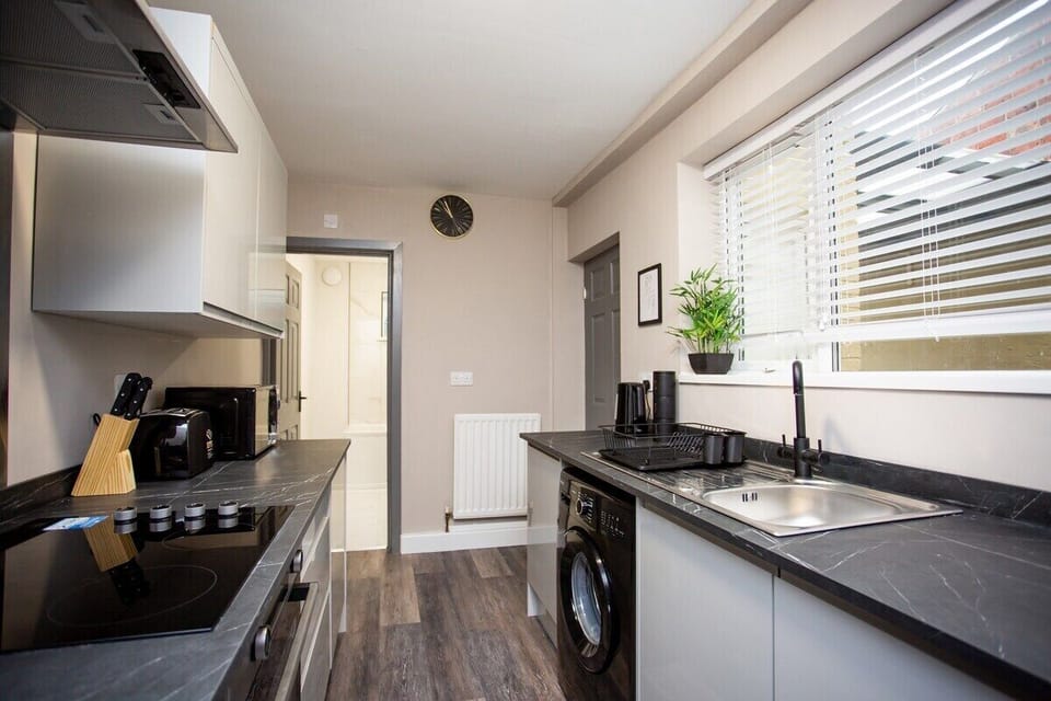 Step into this bright and airy space, where crisp white cabinets provide ample storage for all your cooking essentials, keeping the countertops clutter-free and organized. 