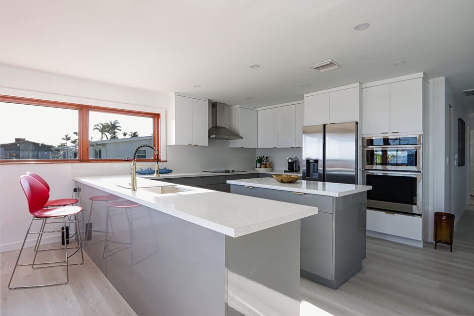 The open-concept kitchen boasts a sleek design with a spacious center island, perfect for streamlined family meal prep