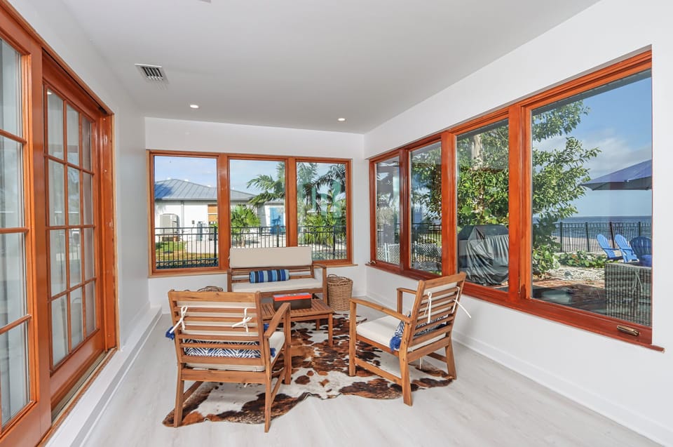 Start your day with the gentle glow of morning light or let the evening hues set the mood as you savor a glass of wine in this intimate sitting area, where tranquil water views inspire calm and reflection
