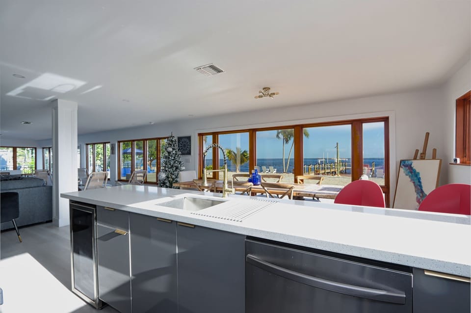 Kick back and cook in this open, airy kitchen featuring stainless steel appliances and large windows that bring in the sunshine and those chill water views