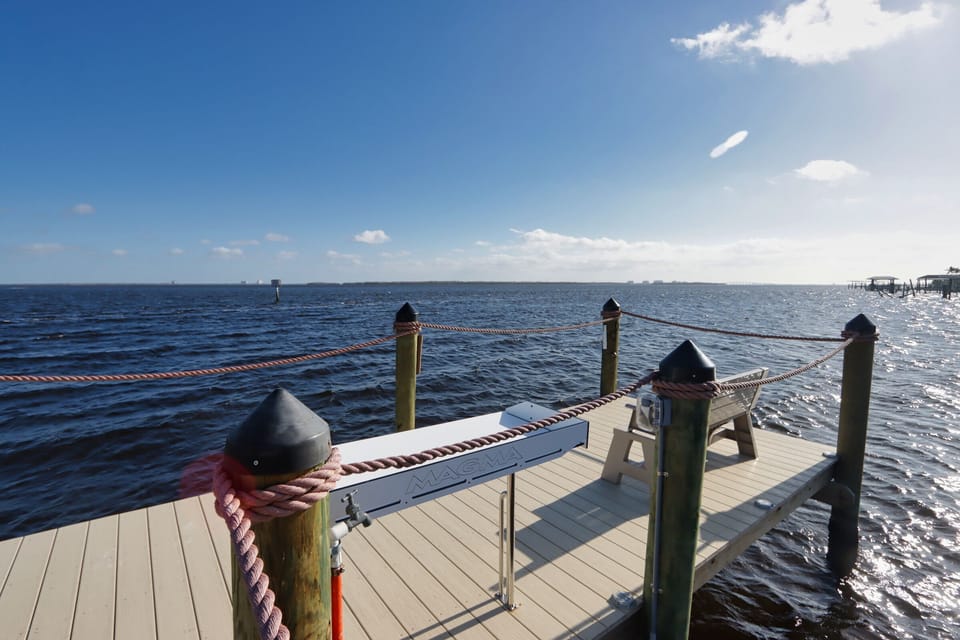 Unwind by the water on your private dock, featuring a fish cleaning station and boat lift, all framed by glistening water views