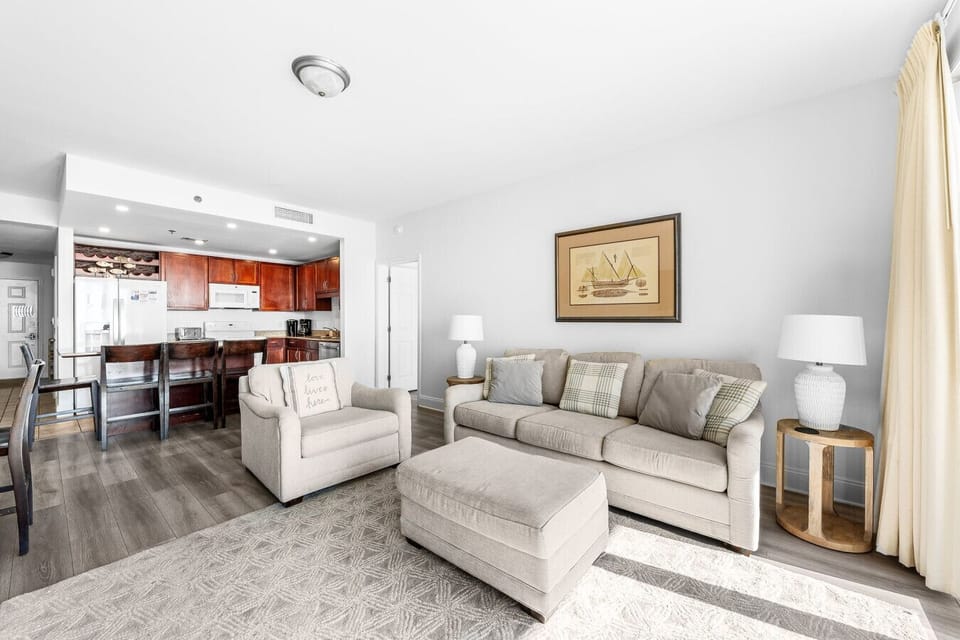 Inviting living space with comfortable seating, a queen-size sleeper sofa, and an open layout connecting to the fully equipped kitchen