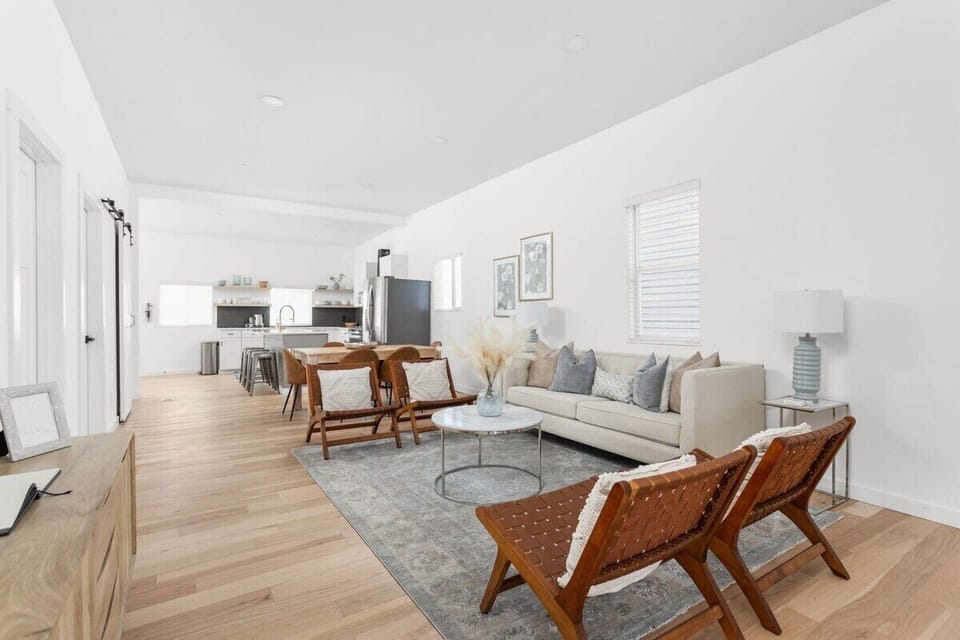 Living Area: Spacious sanctuary with modern decor and warm wood accents for memorable gatherings!