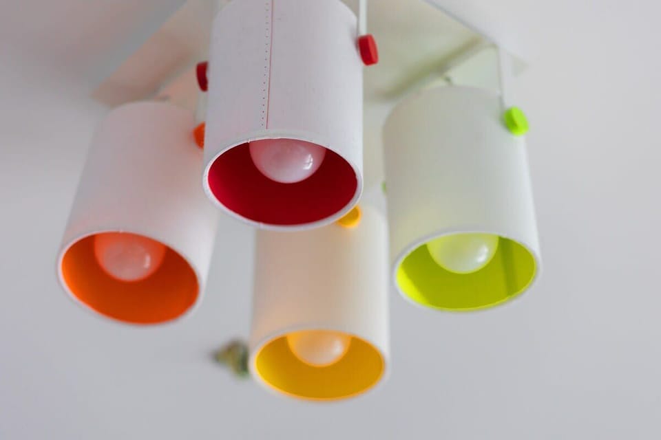 A close-up of colorful pendant lights with vibrant interior shades, adding a playful and modern accent to the room's decor.
