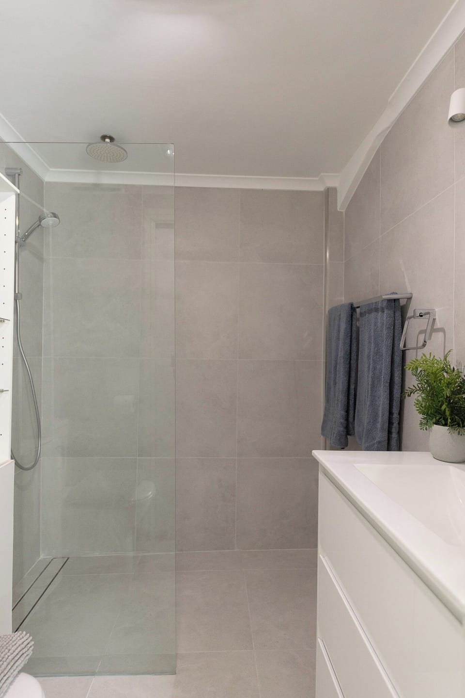 Newly renovated bathroom with walk in shower, vanity and toilet