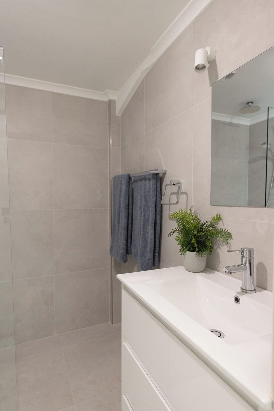 Newly renovated bathroom with walk in shower, vanity and toilet