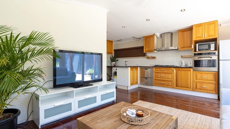 Open Plan living. Please note that there is a dining table with two chairs. Washing machine here also