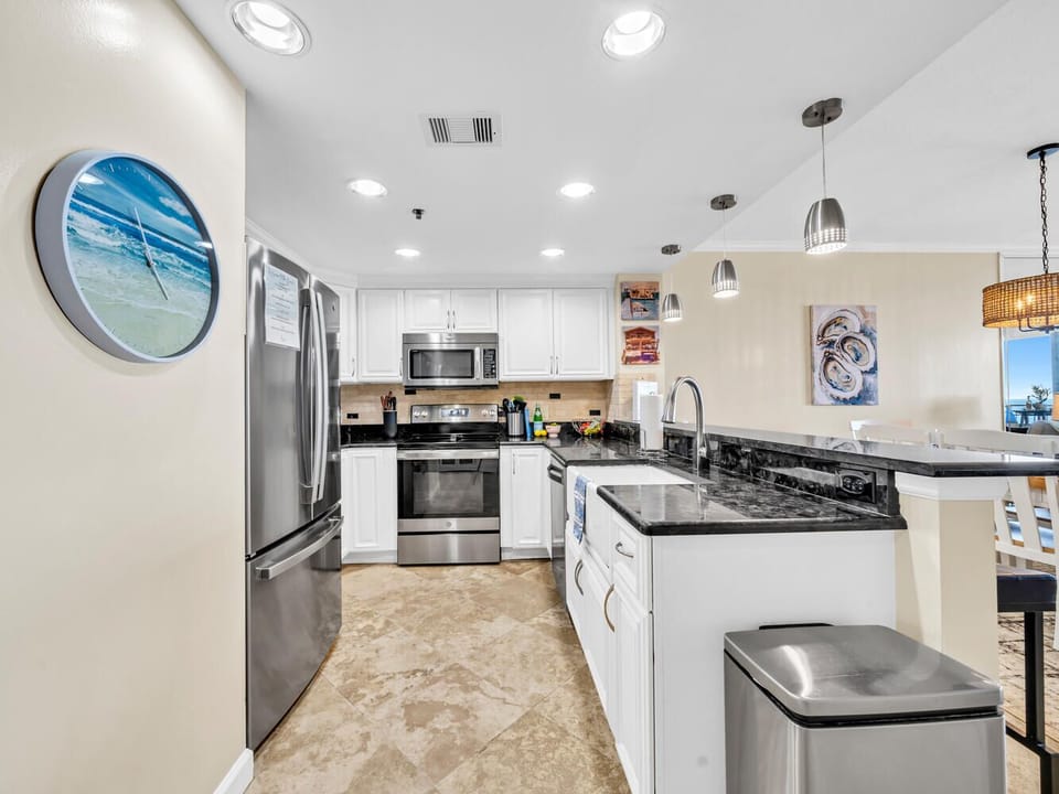 Whip up beachside meals in your sleek kitchen with granite counters, stainless appliances, and coastal art inspiring culinary adventures.