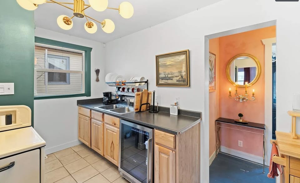 The well-equipped little kitchen includes a wine fridge & cooking utensils