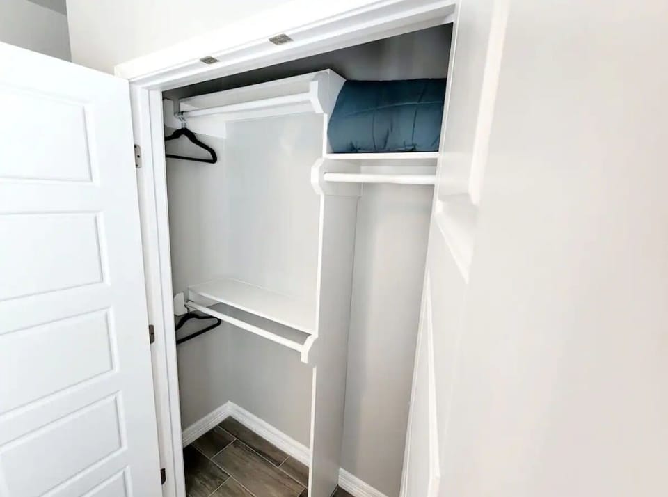 Spacious closet with hangers, portable fan and luggage rack available.