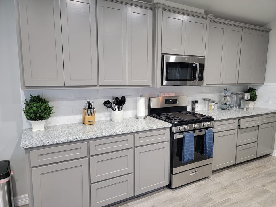 Beautiful spacious kitchen stocked with cooking basics