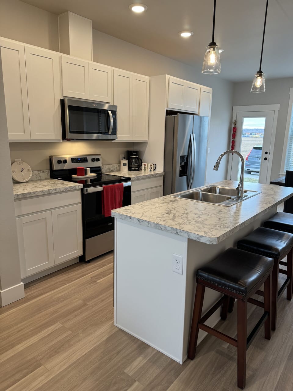 Full kitchen with stainless steel appliances including microwave and dishwasher.