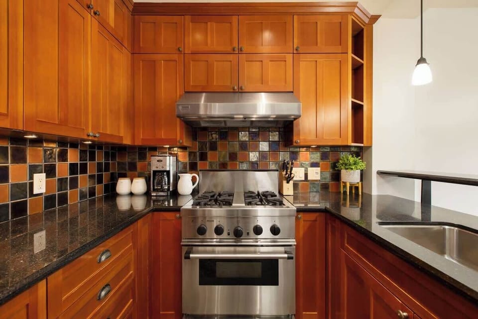 - Gourmet kitchen with stainless steel appliances and warm wood cabinetry  
- Tile backsplash and stone countertops for a classic alpine touch  
- Fully equipped for home-cooked meals after days on Whistler trails  
