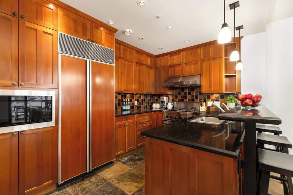 - Spacious kitchen with stainless appliances and rich wood cabinetry  
- Granite countertops and bar seating create a welcoming cooking space  
- Fully equipped for family meals after days on Whistler’s slopes  
