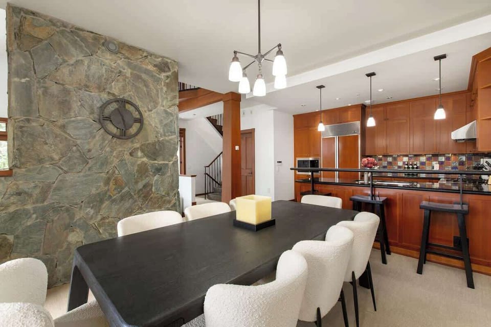 - Elegant dining space blending stone textures and warm wood finishes  
- Open layout connects seamlessly to the modern chef’s kitchen  
- Perfect for family dinners and gatherings with Whistler mountain views  