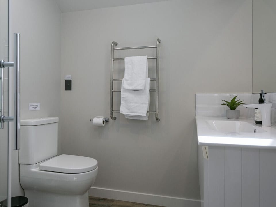 Elegant bathroom with vanity, toilet, and a shower.