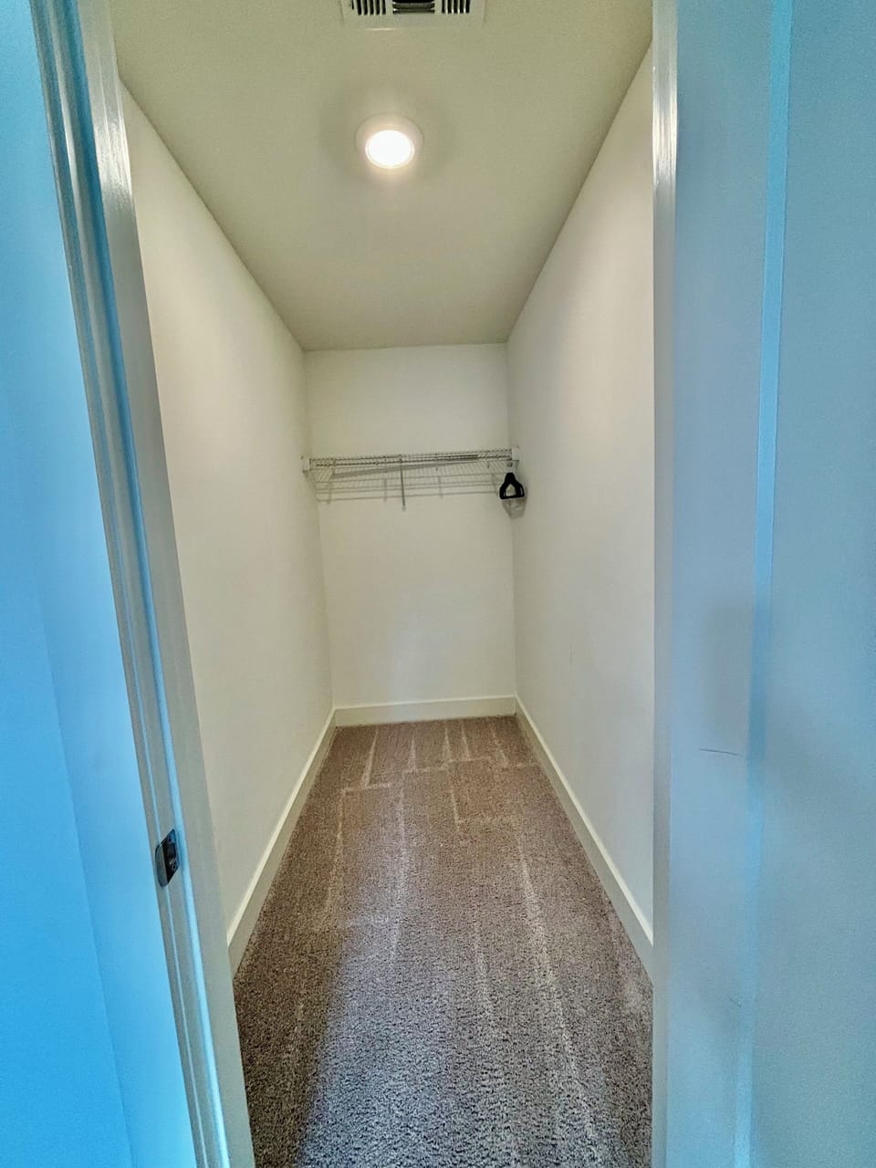 THIRD BEDROOM CLOSET - Third Bedroom Closet with Ample Space, Hangers, and luggage rack in This Nashville Vacation Home. Ideal for Groups or Families, Offering Practical Storage Solutions for Luggage and Personal Items During Your Stay.