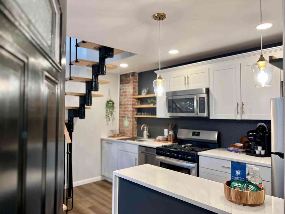 Enter into a bright and airy kitchen with peninsula and counter seating.
