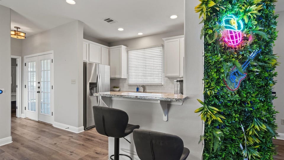 Brand new kitchen area with art wall and bar stools 
