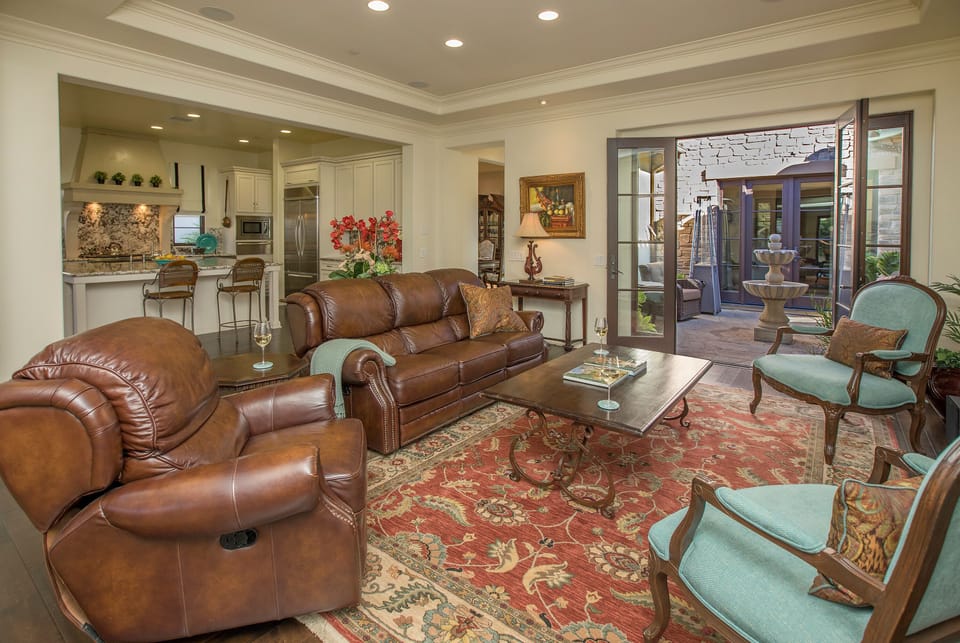 The Kitchen opens up to the cozy Great Room with doors that lead out to the center courtyard with water feature.