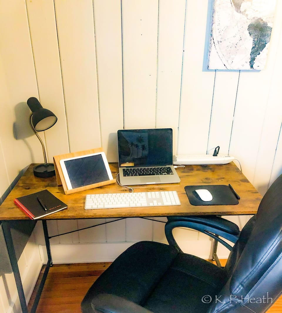 Fully equipped desk with light and executive chair for remote work/learning.