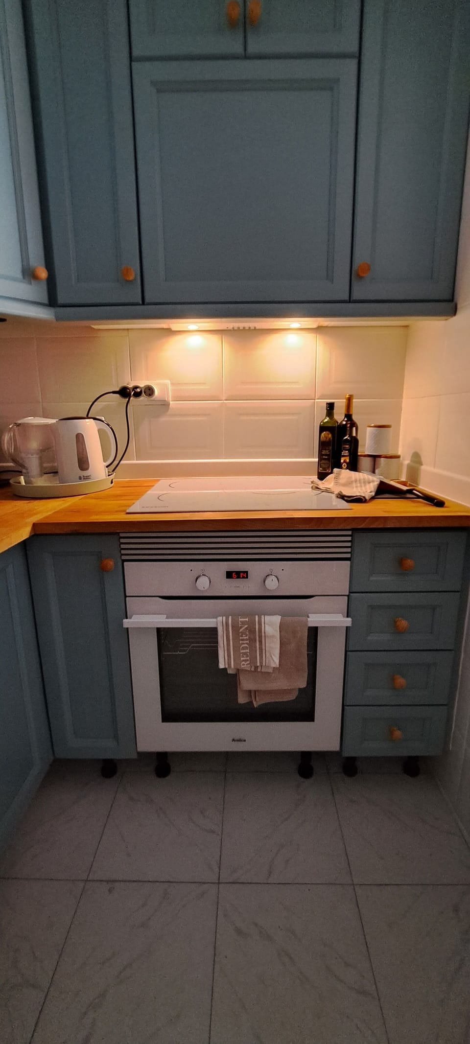 Kitchen with Induction hob, oven, refrigerator, coffee machine, electric kettle.