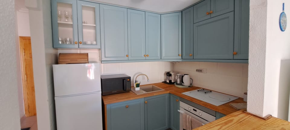 Kitchen with Induction hob, oven, refrigerator, coffee machine, electric kettle.