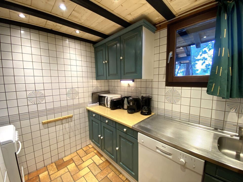 Kitchen with fridge, stove, microwave, coffee maker, kettle, dishwasher