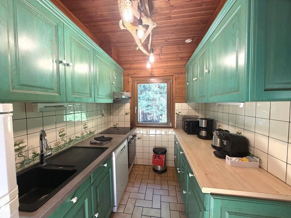 Kitchen with fridge, stove, microwave, coffee maker, kettle, dishwasher