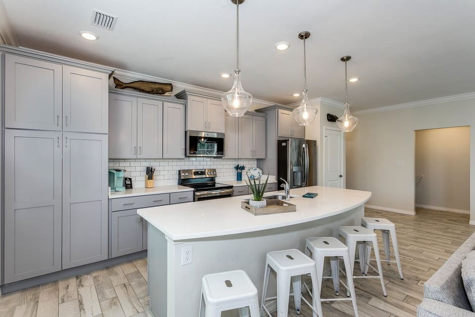 Breakfast bar at the kitchen island with seating for five. 