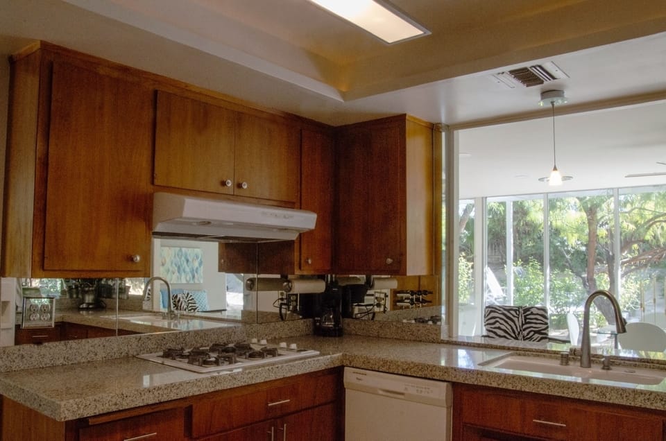 Kitchen with granite countertops and teak cabinets