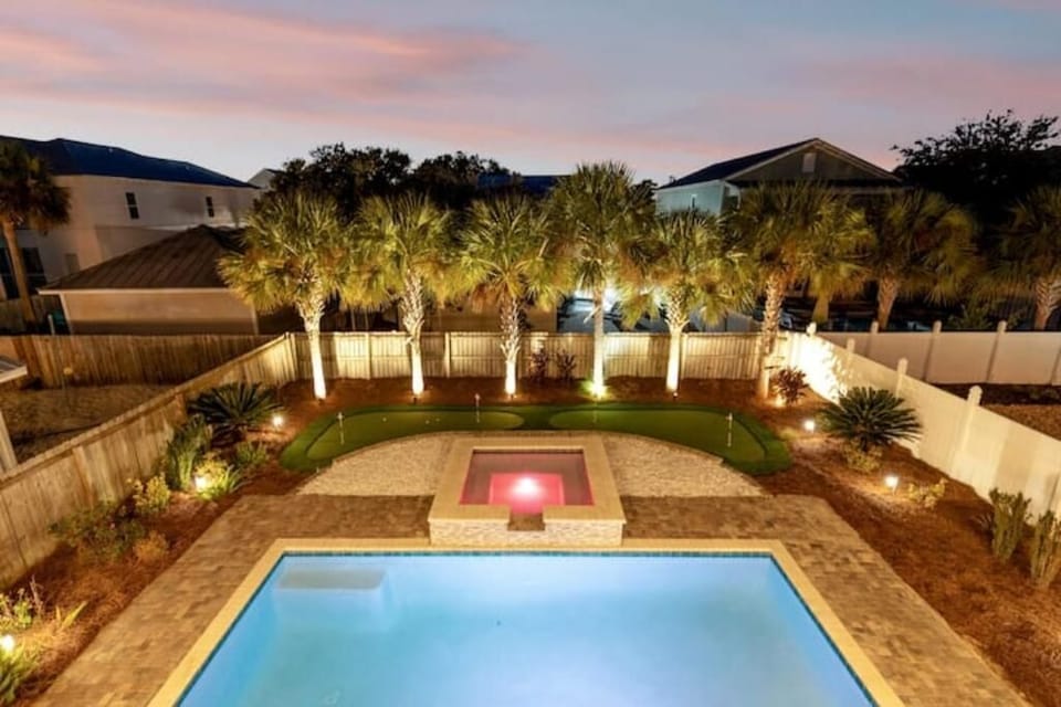 Oasis style backyard with heated pool*, putting green  and hot tub