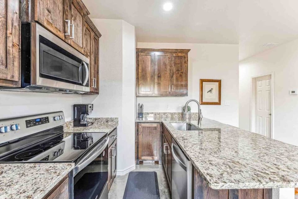 Fully stocked kitchen with range/oven, dishwasher, microwave, refrigerator, all dishes, utensils, pots, pans, toaster, blender, keurig, and more!