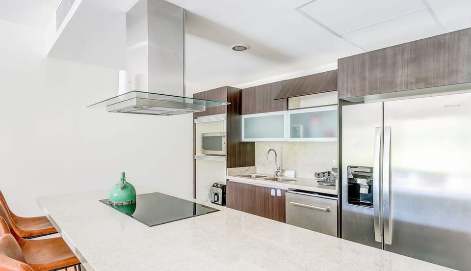 Fully equipped kitchen with stainless steel appliances & a big center island bar