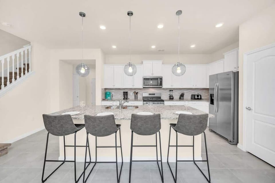 Modern kitchen with granite island and seating for four
