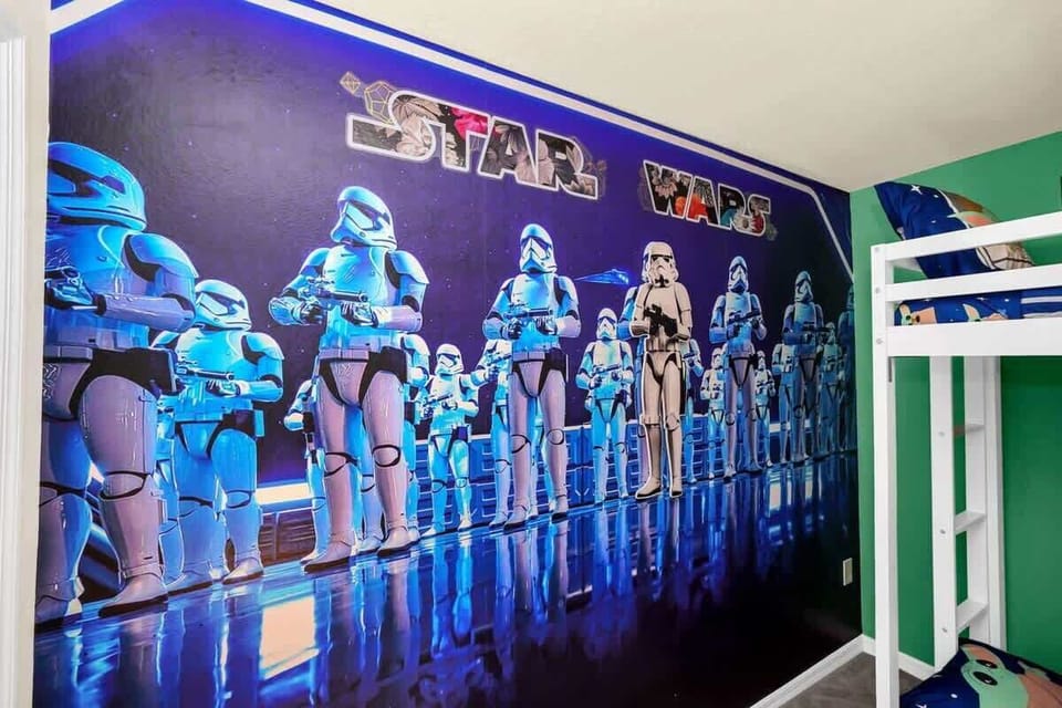 Star Wars-themed bedroom with a vibrant stormtrooper mural and bunk beds.