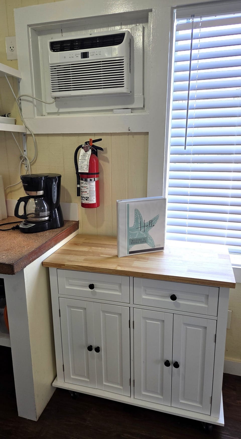 The cottage has a drip coffee maker and a kitchen cart with extra storage