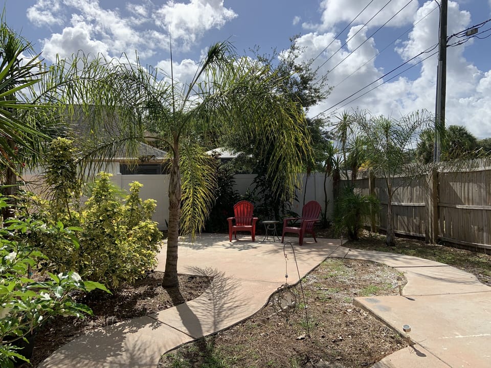 Fully fenced backyard with seating and space for a small dog to run. 