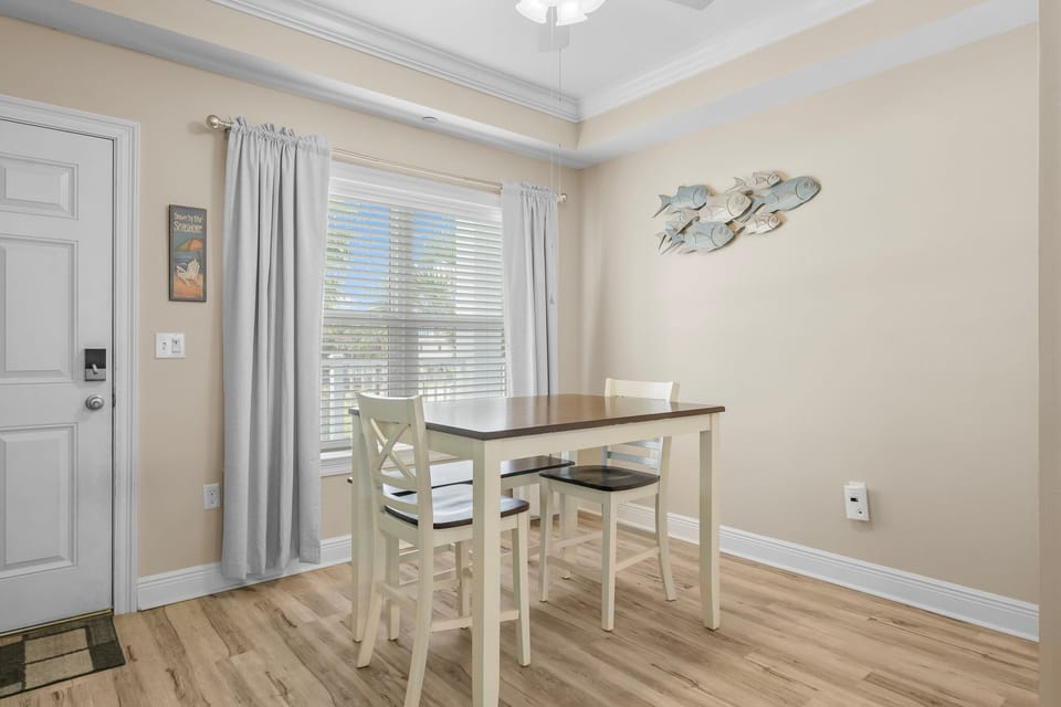 Gather around your charming dining table with coastal fish art creating a beachy atmosphere for memorable meals together.