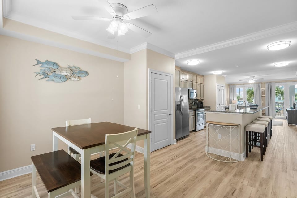 Your coastal-themed kitchen and dining space flows beautifully with ocean artwork, granite counters, and room for memorable meals together.