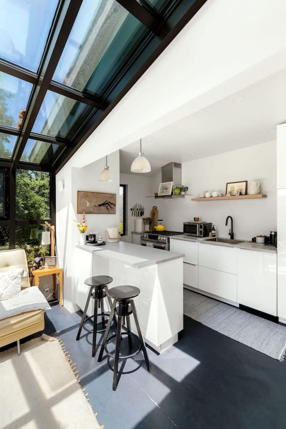 Clean and Spacious Kitchen with Sleek Countertops and Additional Seating