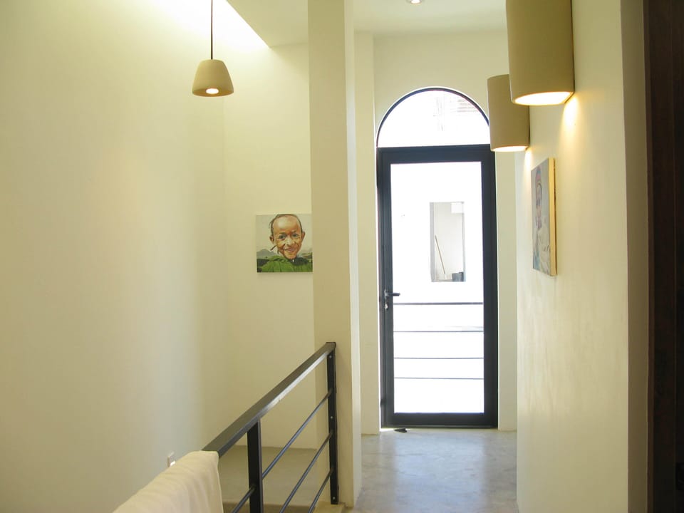 Second floor has bedrooms with door up to third floor palapa