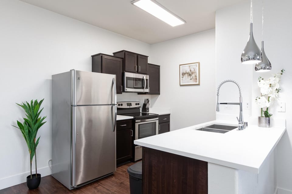 Fully equipped kitchen with stainless steel appliances.