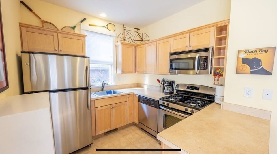 Kitchen, with microwave, coffe maker, dishes, pots pans and dishwasher.