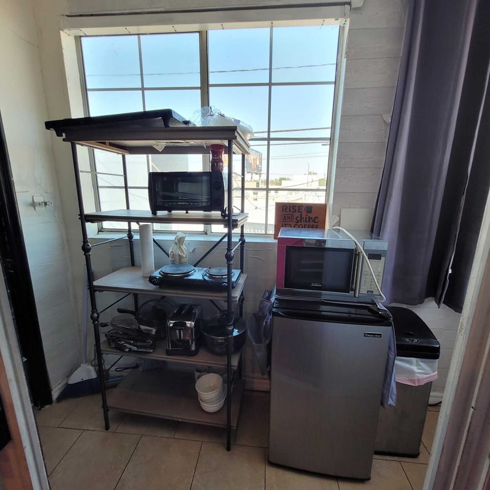 Toaster, mini-fridge, microwave, toaster, Eye, dishes, silverware. 