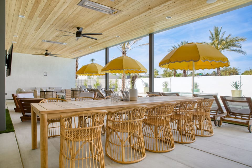 Covered patio lounge with an al fresco dining area and comfortable outdoor seating.