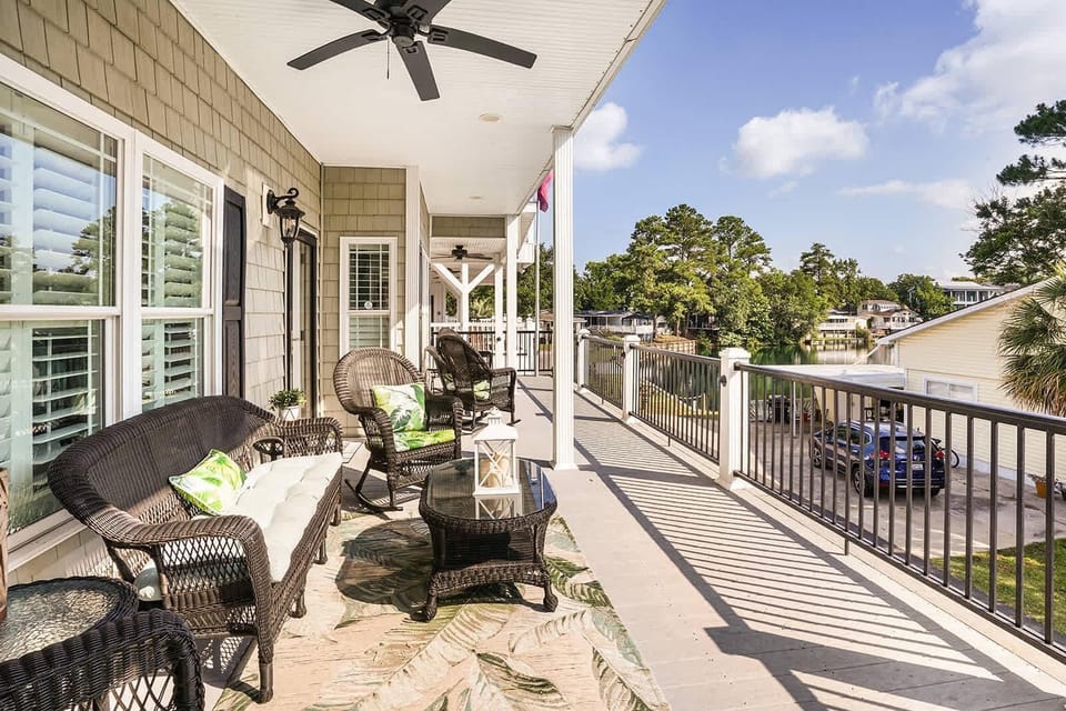 Spacious covered patio with cozy seating and ceiling fans