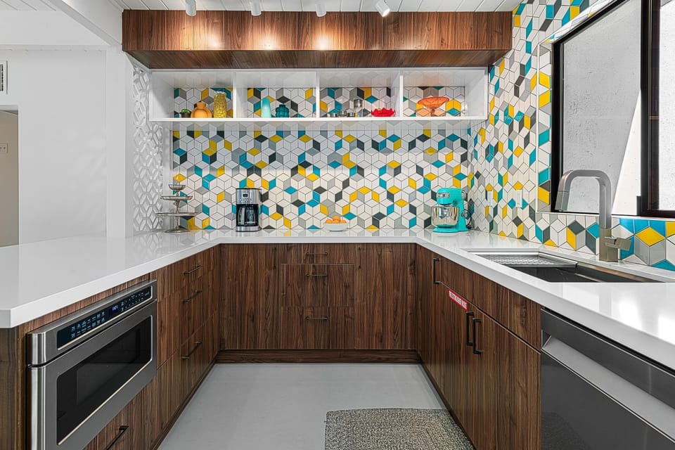 Vibrant geometric backsplash brightens the kitchen as well as the natural light