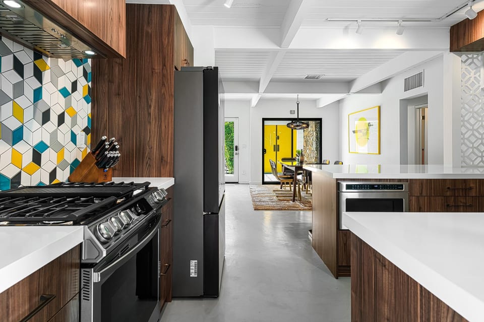 Fully stocked kitchen with 5-burner gas range and griddle & stainless appliances